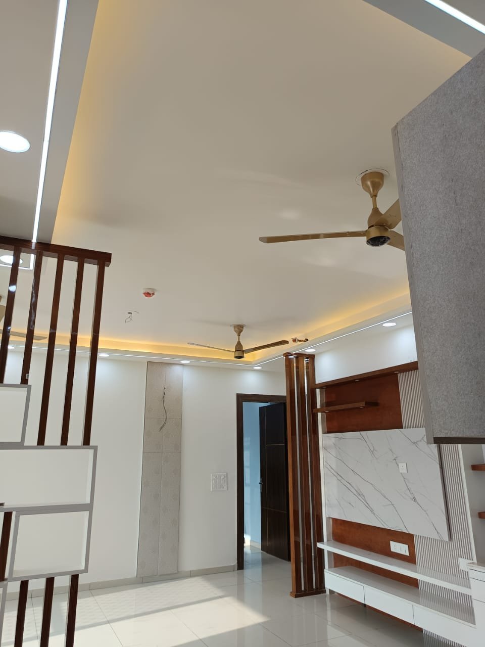 Entryway with cove-lit false ceiling and wooden partition screen